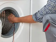 Dryer repair technician diagnosing and servicing a clothes dryer in Henderson, NV
