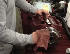 Vacuum repair technician cleaning and servicing a vacuum motor in Henderson, NV
